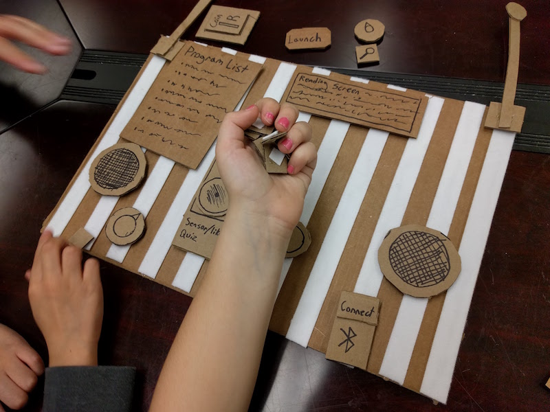 Prototypes with cardboard pieces representing features on a velcro based board